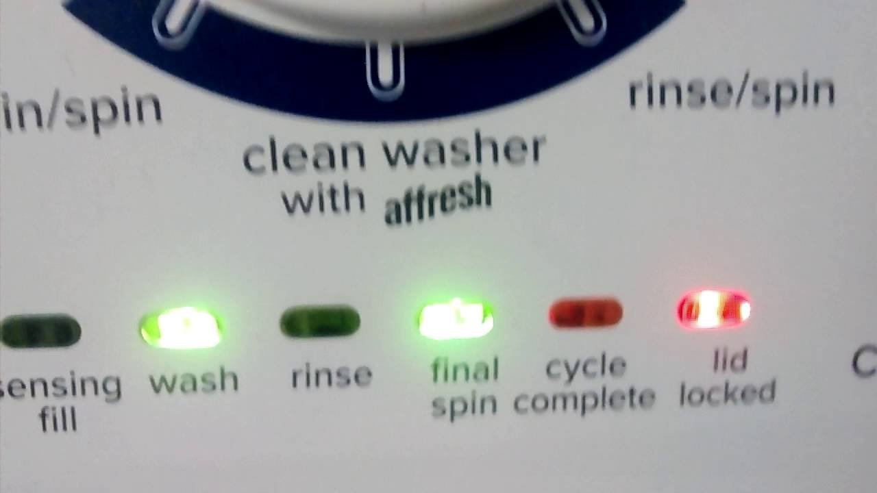 An unbalanced load of laundry inside the metal drum of an Amana washing machine.
