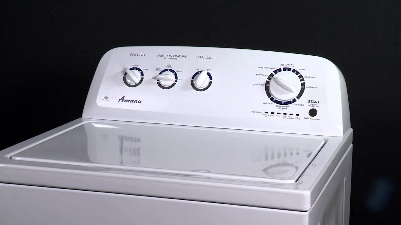 Cleaning a sediment-clogged mesh screen from the water inlet of an Amana washer.