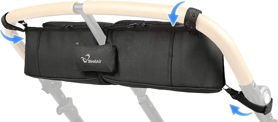 A modern baby stroller with a convenient cup holder parked in a sunny park.