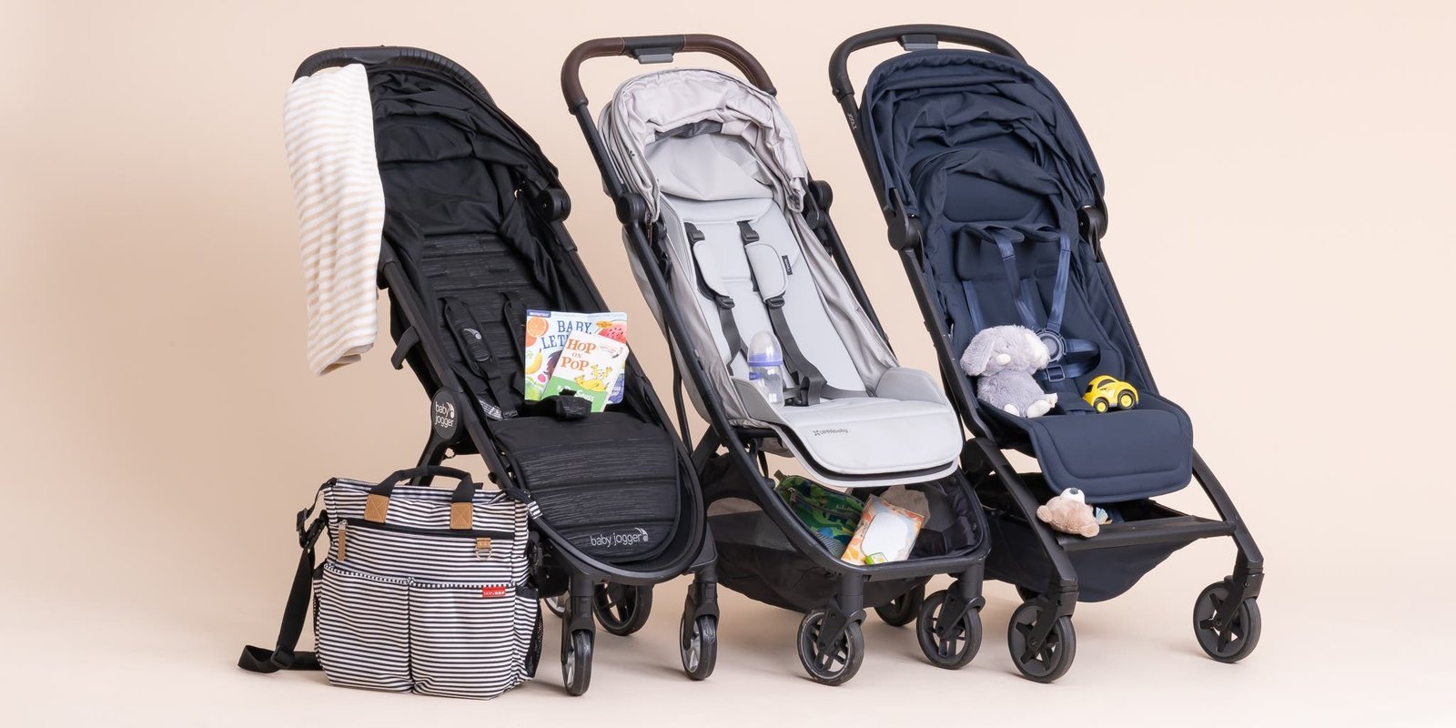A durable baby stroller travel bag sits in a bright airport terminal.