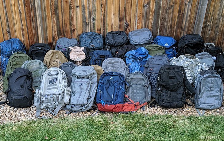 A well-organized bug out bag for families sits ready in a bright home entryway.