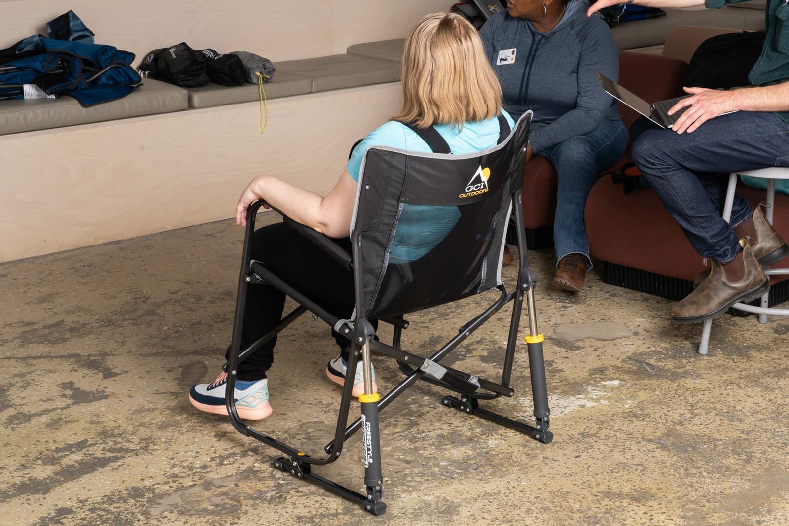 A comfortable and sturdy camping chair designed for older adults in a scenic meadow.
