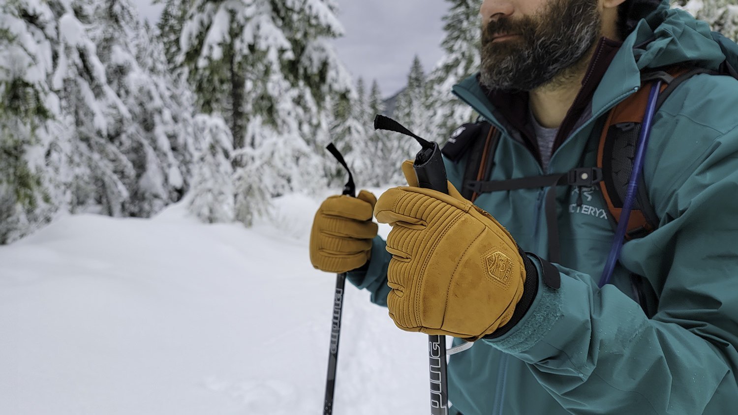 Premium leather mittens resting on a snowy fence as the best cold weather mittens.