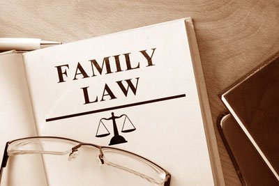 A collection of authoritative family law books arranged on a modern wooden desk.