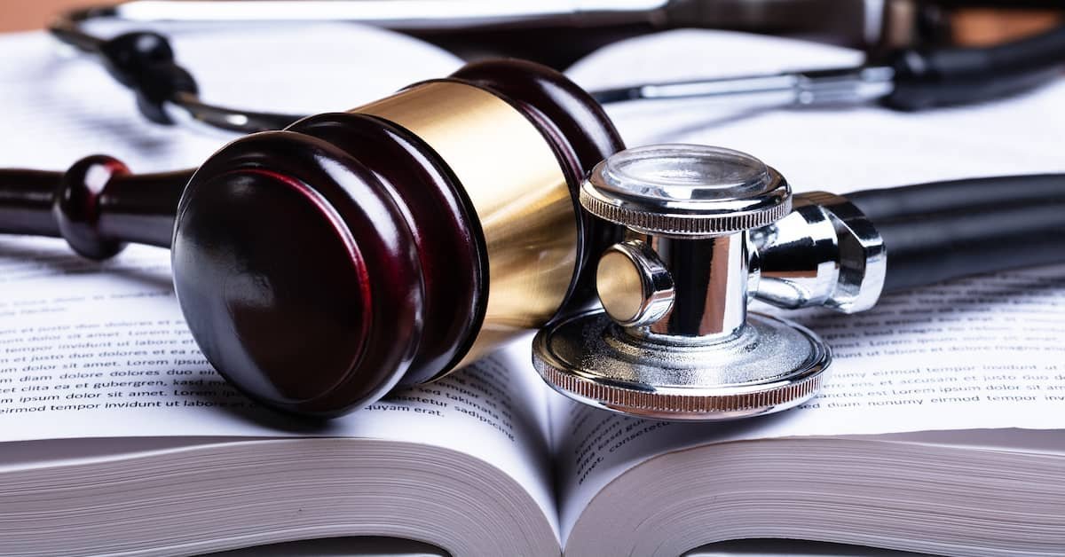 A collection of professional legal textbooks on medical malpractice sitting on a library table.