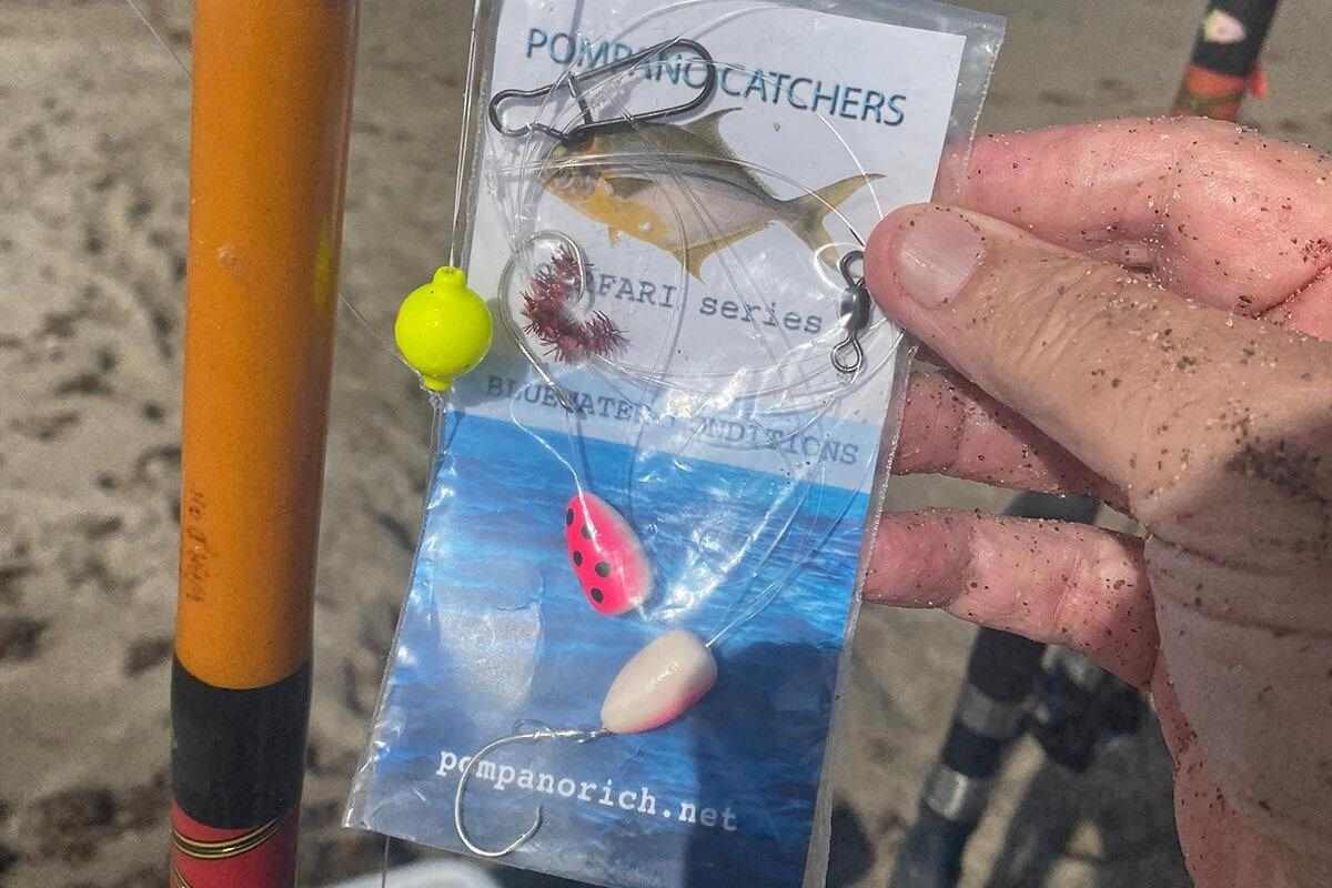 A variety of effective surf fishing lures resting on a wooden pier.
