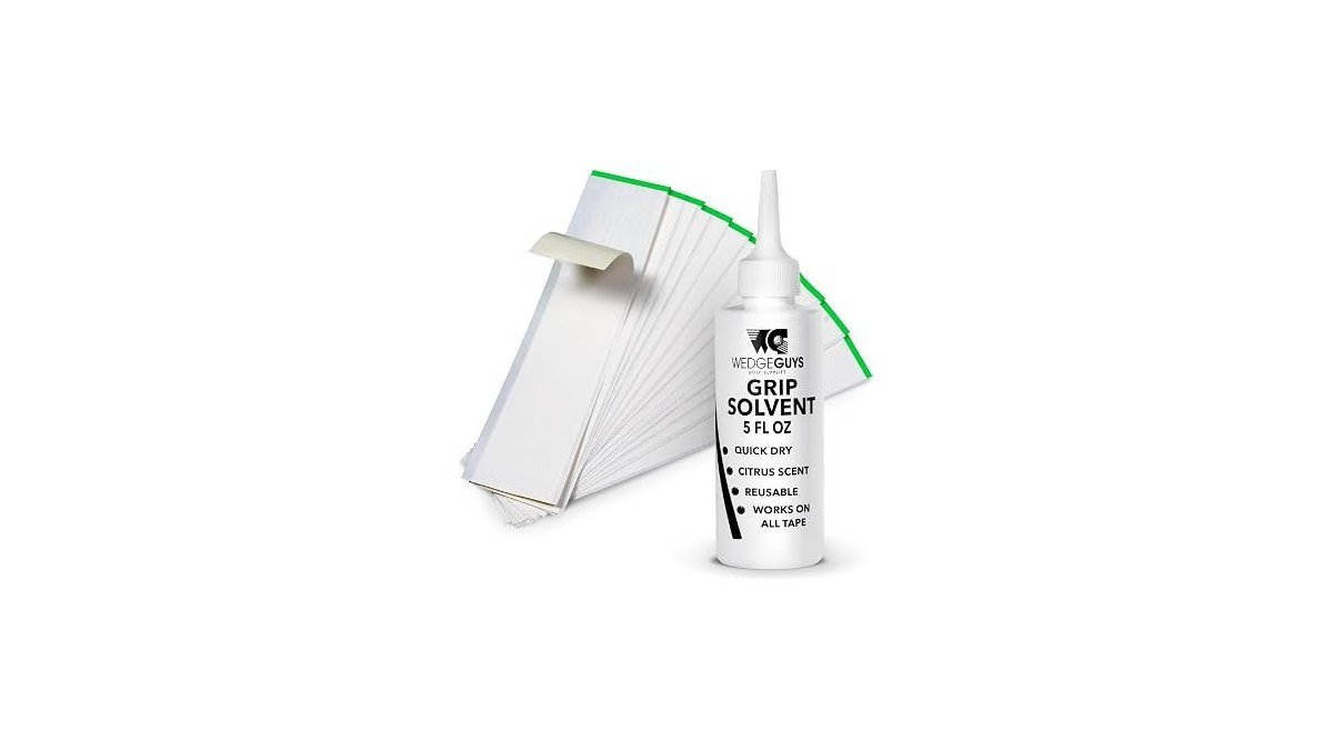 Essential tools for golf club grip repair kits arranged on a clean wooden workbench.