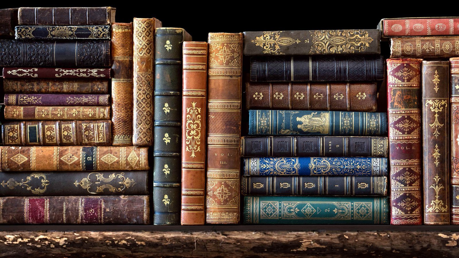 A stack of historical biography books about the Middle East on a wooden table.