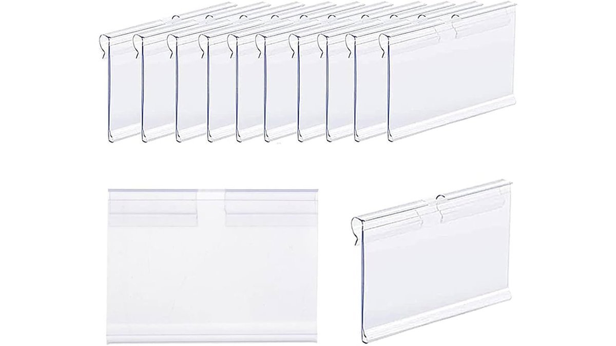 A collection of clear price tag holders displayed on a modern retail shelf.