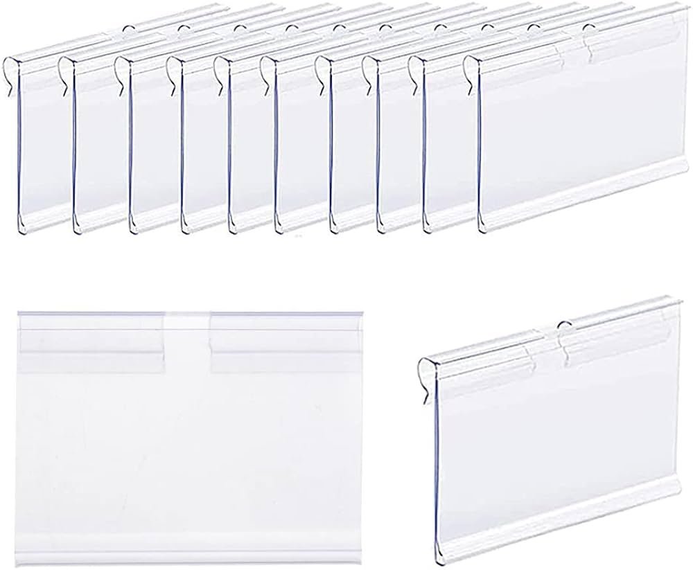 A collection of clear price tag holders displayed on a modern retail shelf.