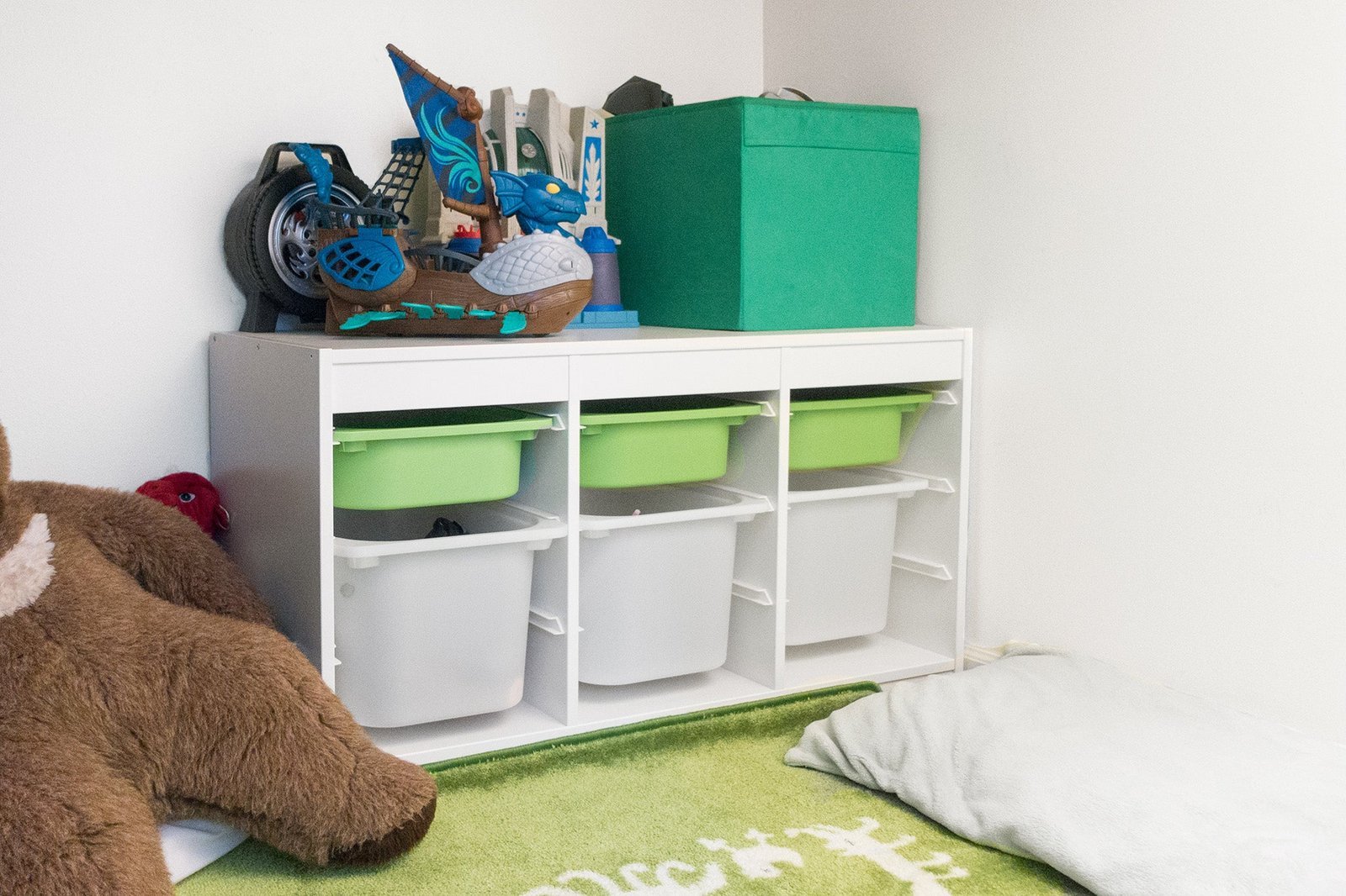 A clean and organized playroom featuring a modern toy storage unit for toddlers.