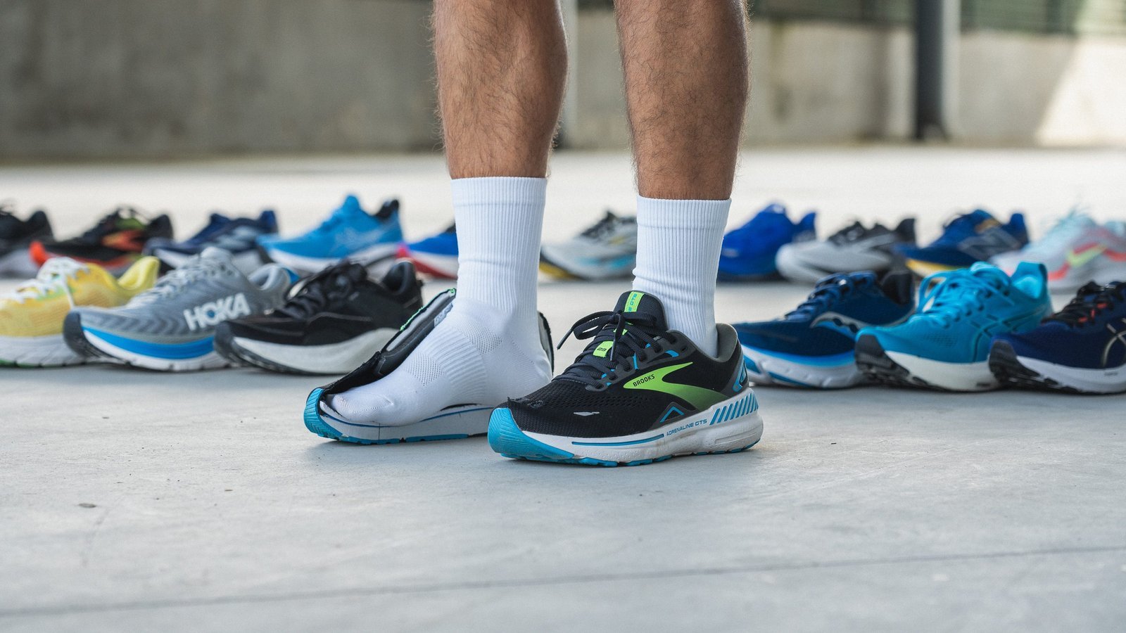 High-performance trail running shoes with medial support displayed on a rugged mountain path.