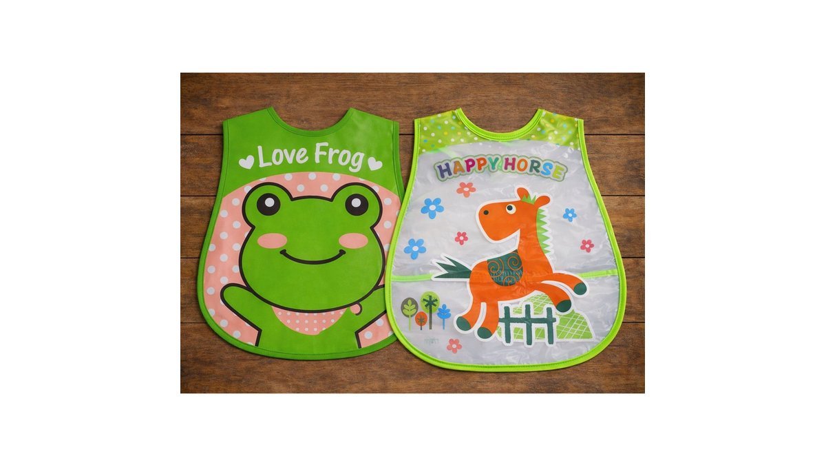A waterproof baby bib sits on a wooden high chair ready for feeding.