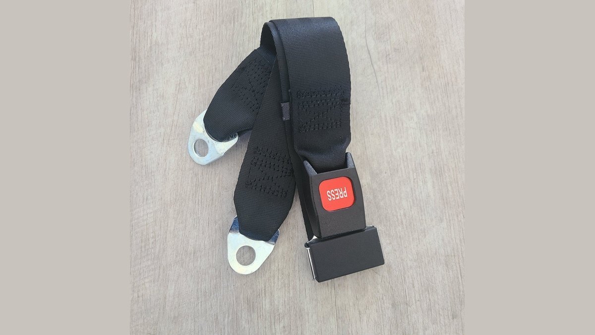 A secure safety belt on a modern mobility scooter seat in a showroom.