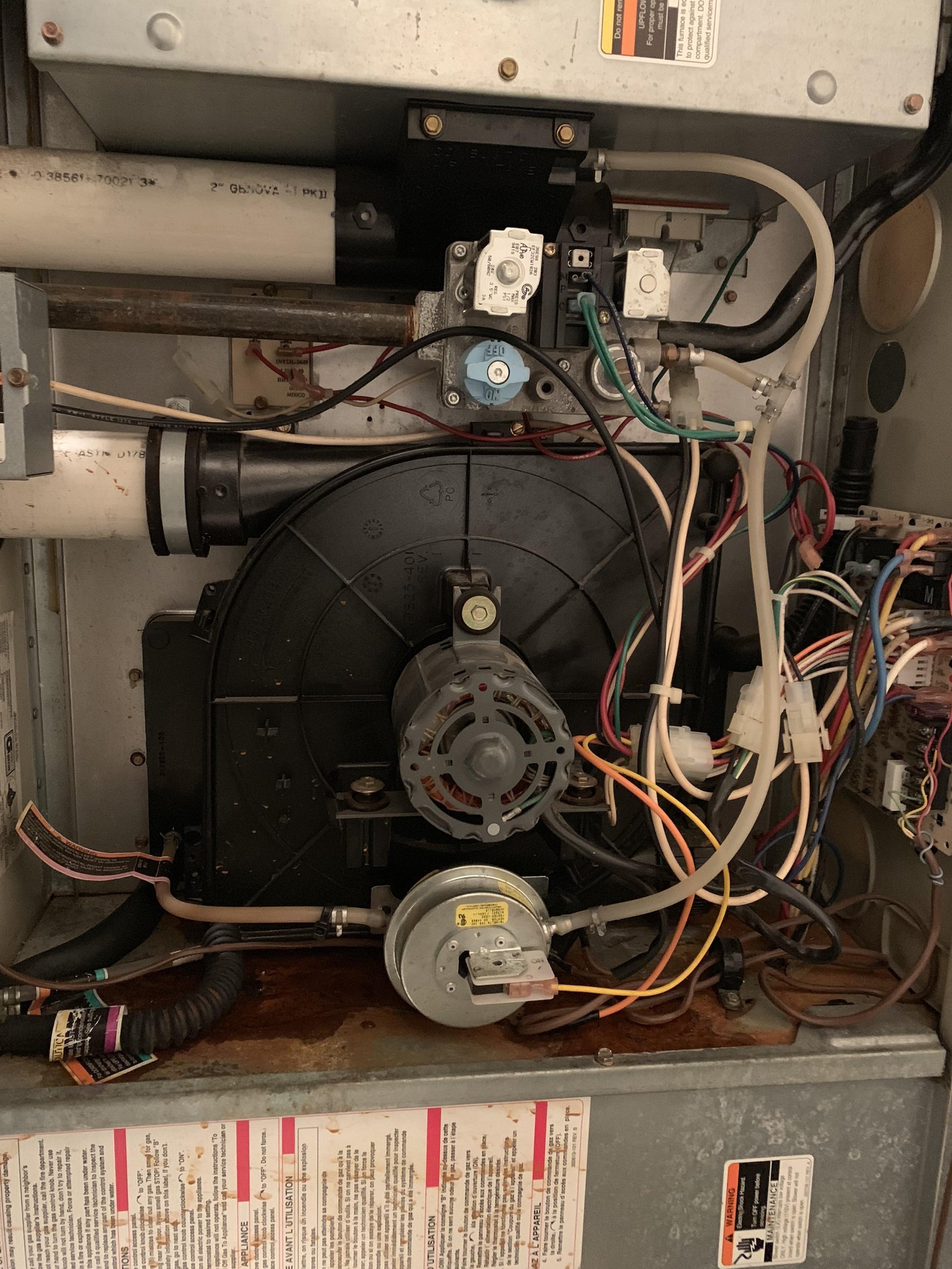 A heavily dust-clogged air filter sits near a furnace causing airflow issues.