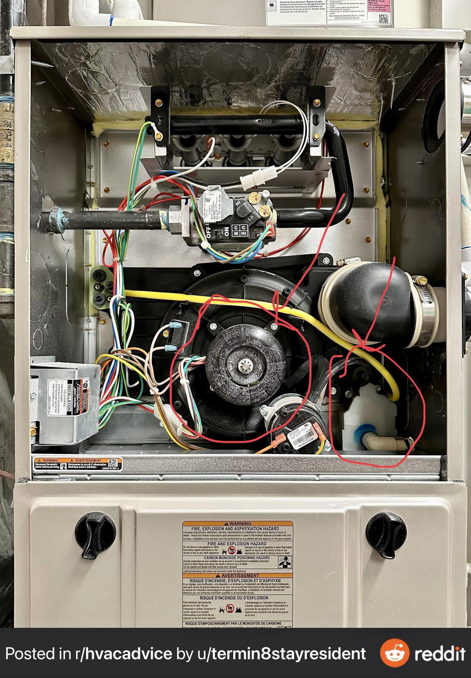 Hands carefully replacing a clean air filter in a residential furnace unit.