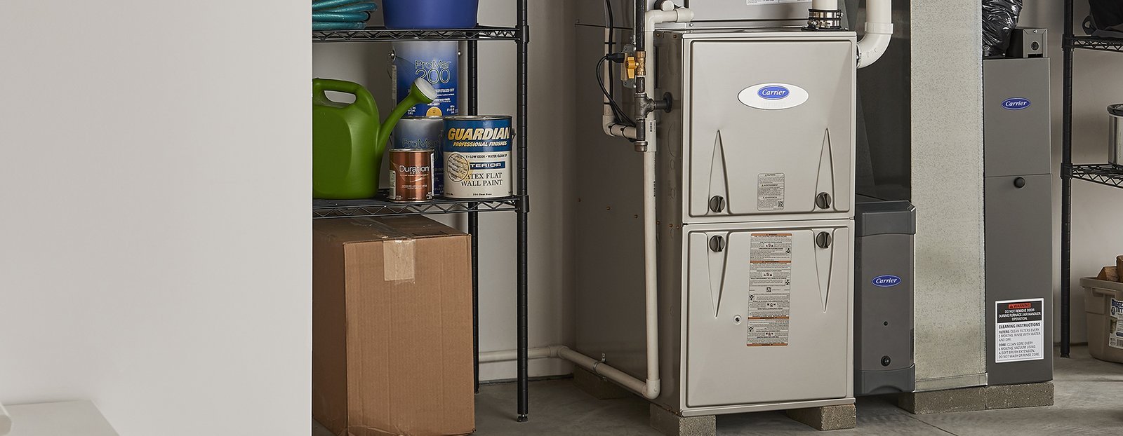 A homeowner checks the digital thermostat settings to ensure the furnace is heating.
