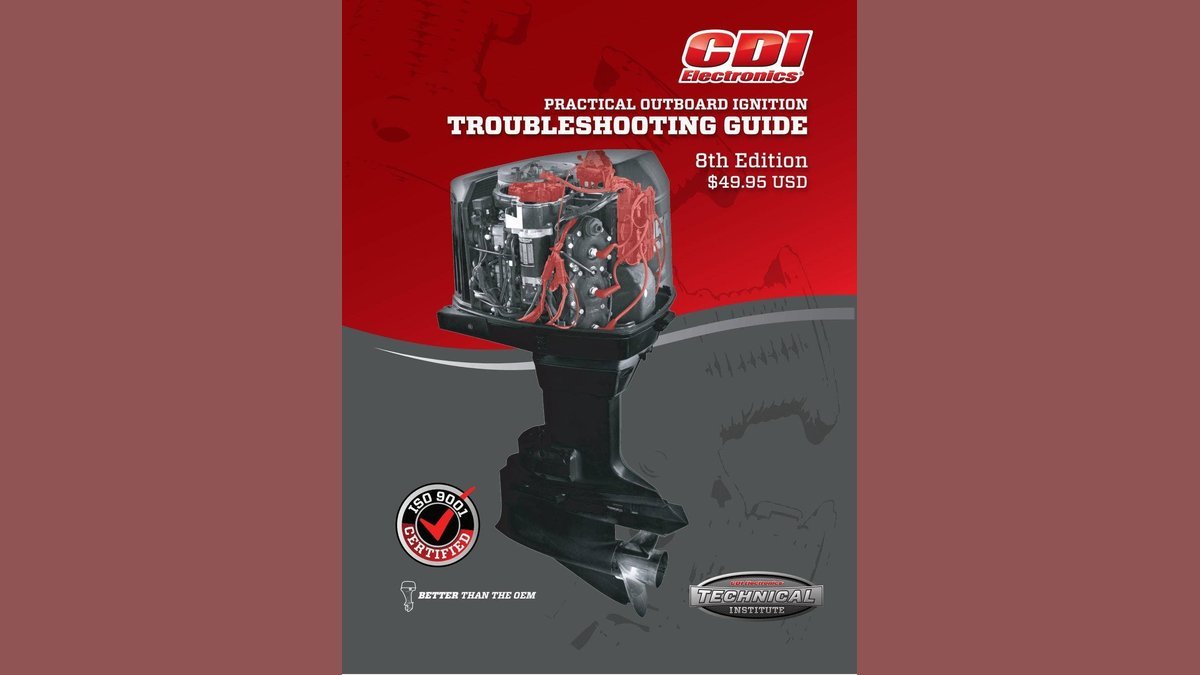A technician performing professional CDI electronics troubleshooting on a marine engine in a workshop.