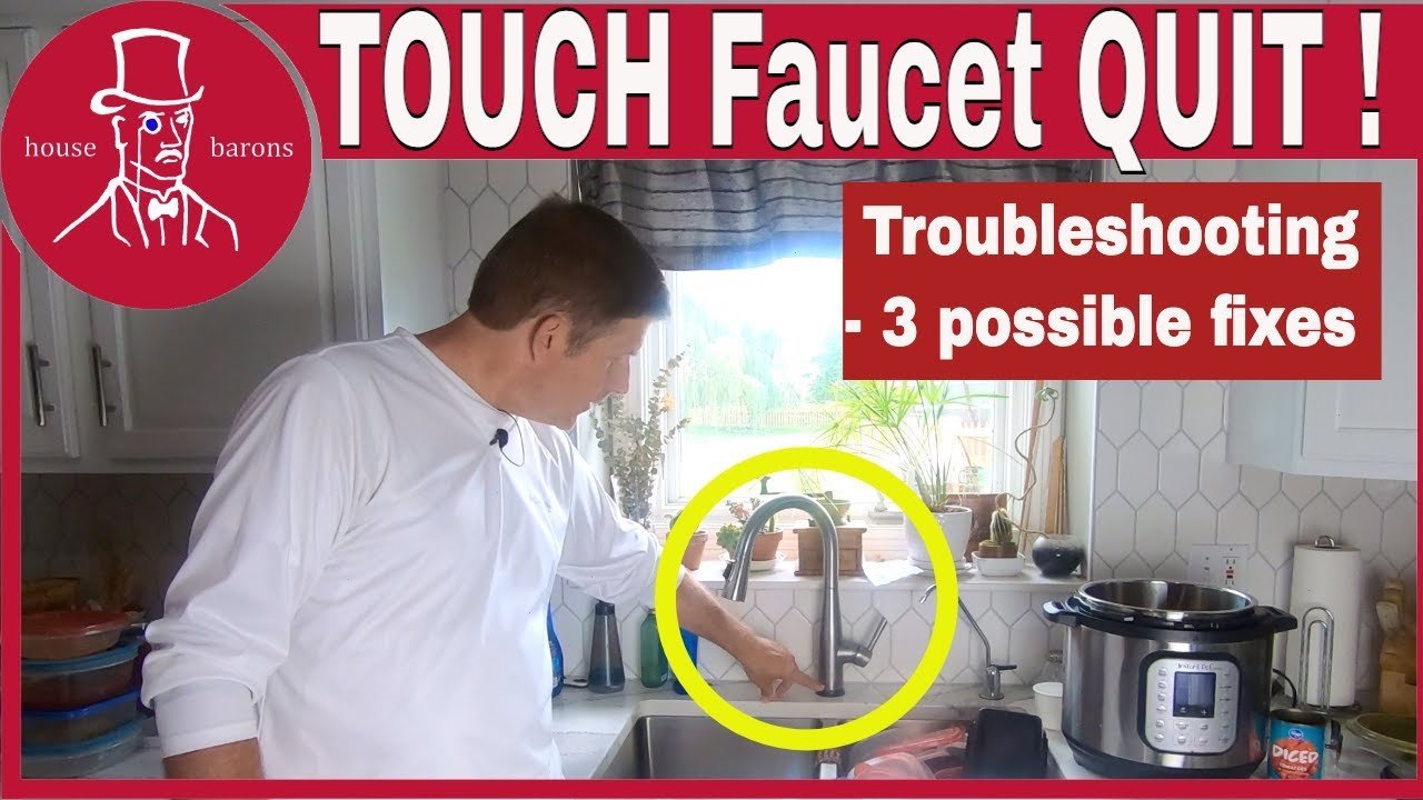 A modern chrome touchless kitchen faucet stands in a bright, clean residential kitchen.