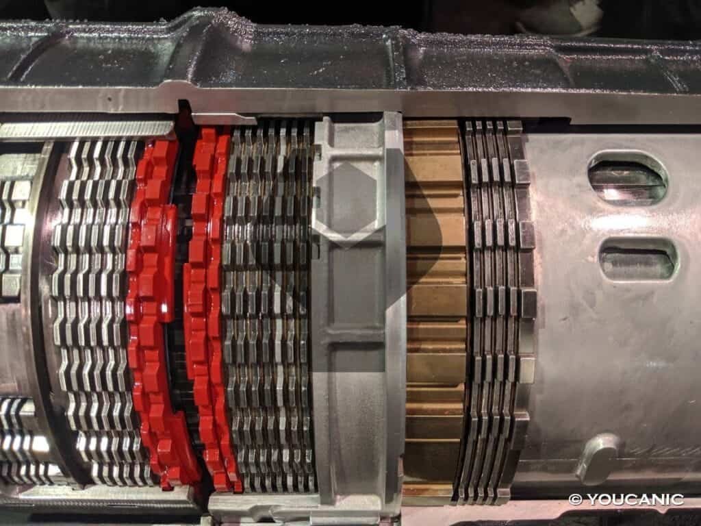 Close up of transmission fluid and mechanical gears illustrating common transmission failure causes.