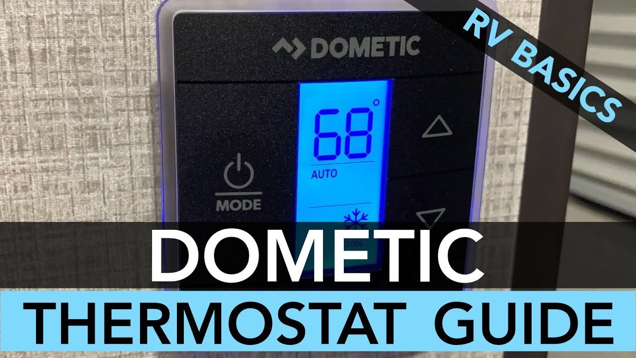 Reading an RV manual while troubleshooting a Dometic thermostat.
