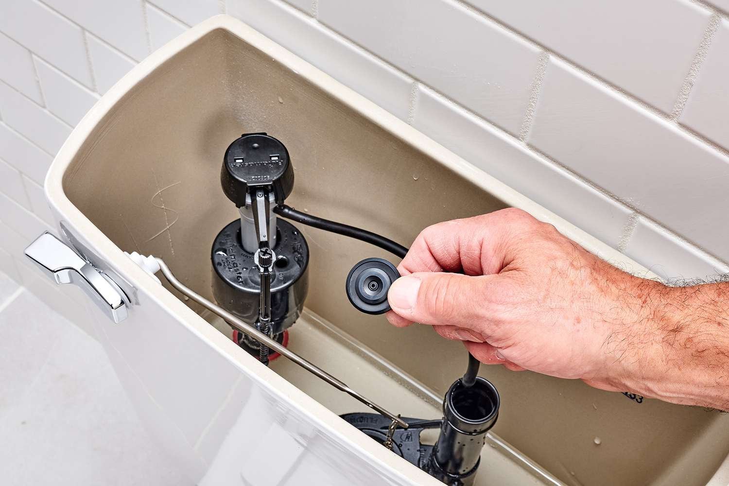 Plumbing tools arranged neatly for answering common toilet repair questions.