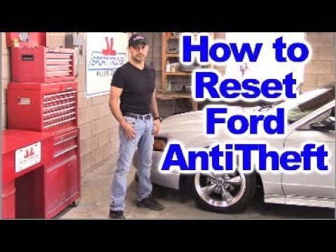Modern Ford key fob resting on a dashboard for anti theft system troubleshooting.