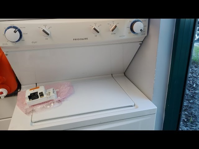 A modern Frigidaire front-load dryer in a bright and clean laundry room setting.