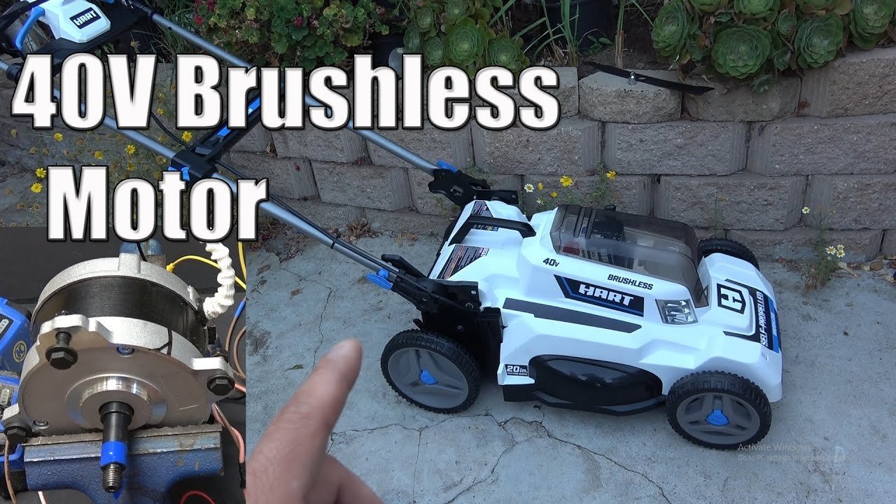 A modern electric Hart lawn mower standing on a well-maintained green suburban lawn.