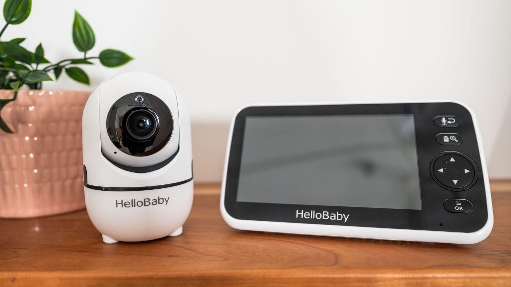 A reliable non-wifi baby monitor sits on a nursery table in a cozy room.