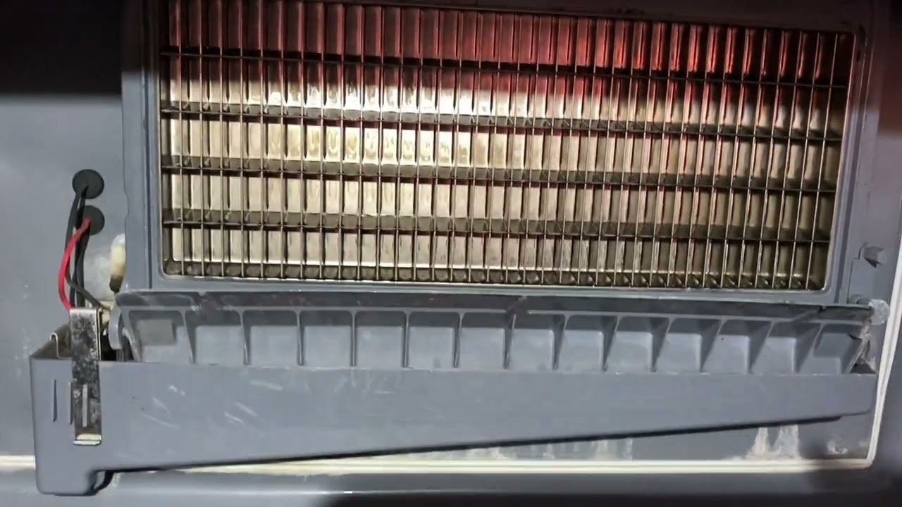 Mineral scale buildup on the internal sensor and evaporator plate of an ice machine.