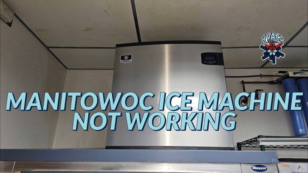 A technician inspects a professional Manitowoc ice machine in a commercial kitchen setting.