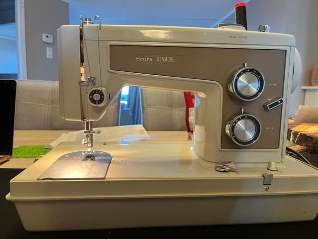 Organized sewing supplies and tools arranged for Kenmore machine troubleshooting.