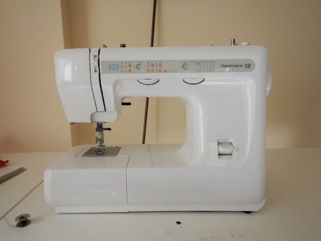 A vintage Kenmore sewing machine ready for a project on a clean desk.