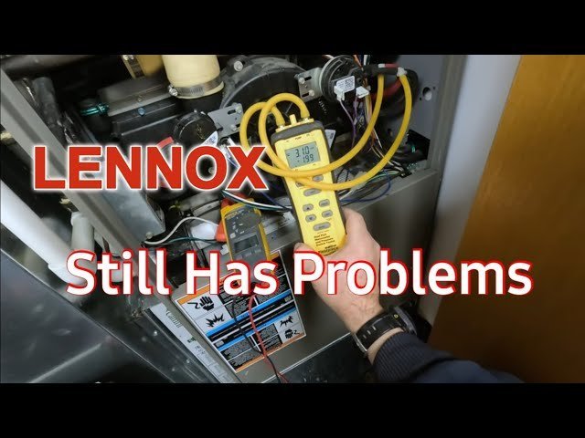 A technician replacing a dusty air filter in a residential Lennox heating system unit.