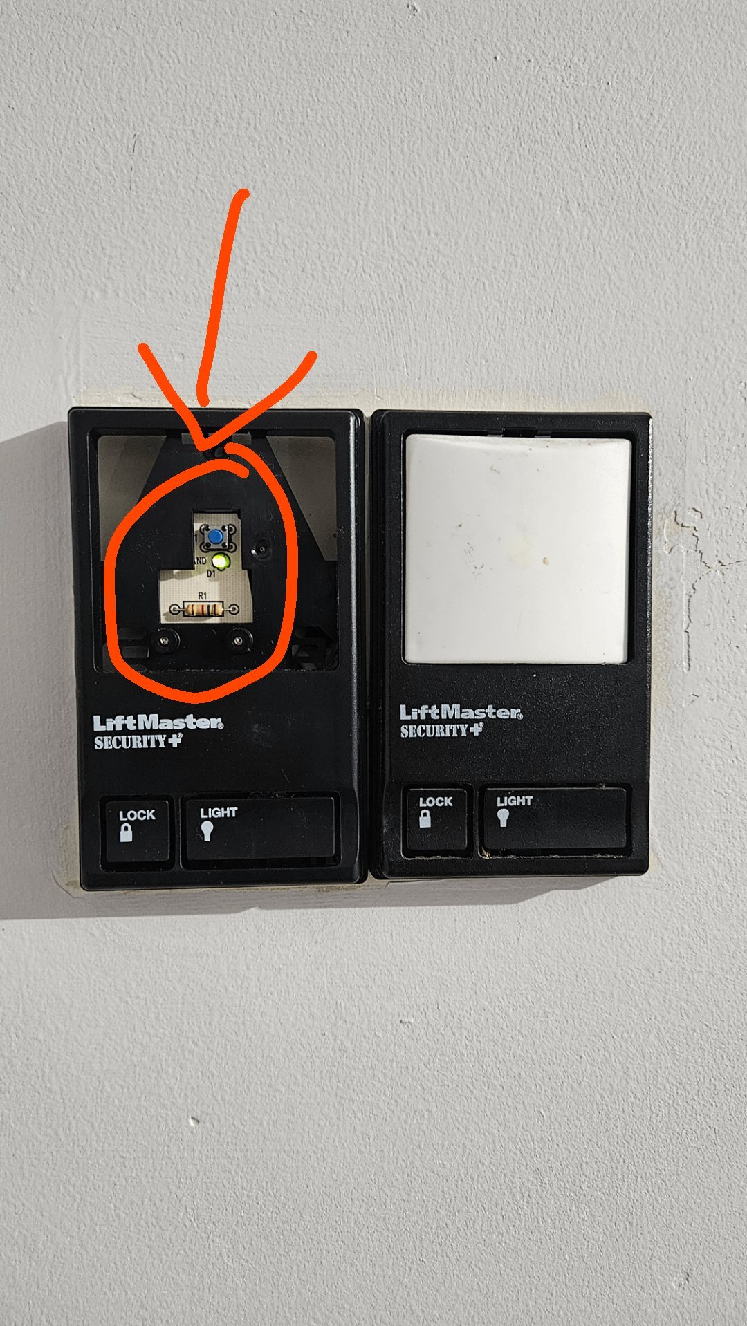 Insulated wire clips and a garage remote resting on a clean workbench.