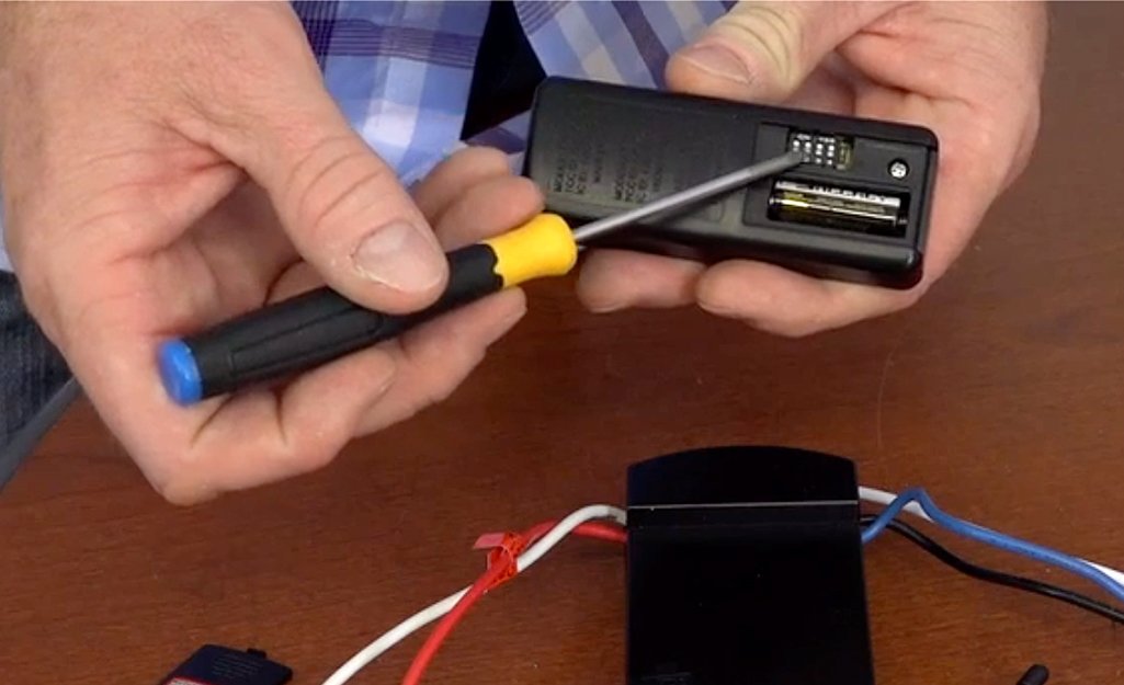 A handheld Monte Carlo fan remote sitting on a table in a modern living room.