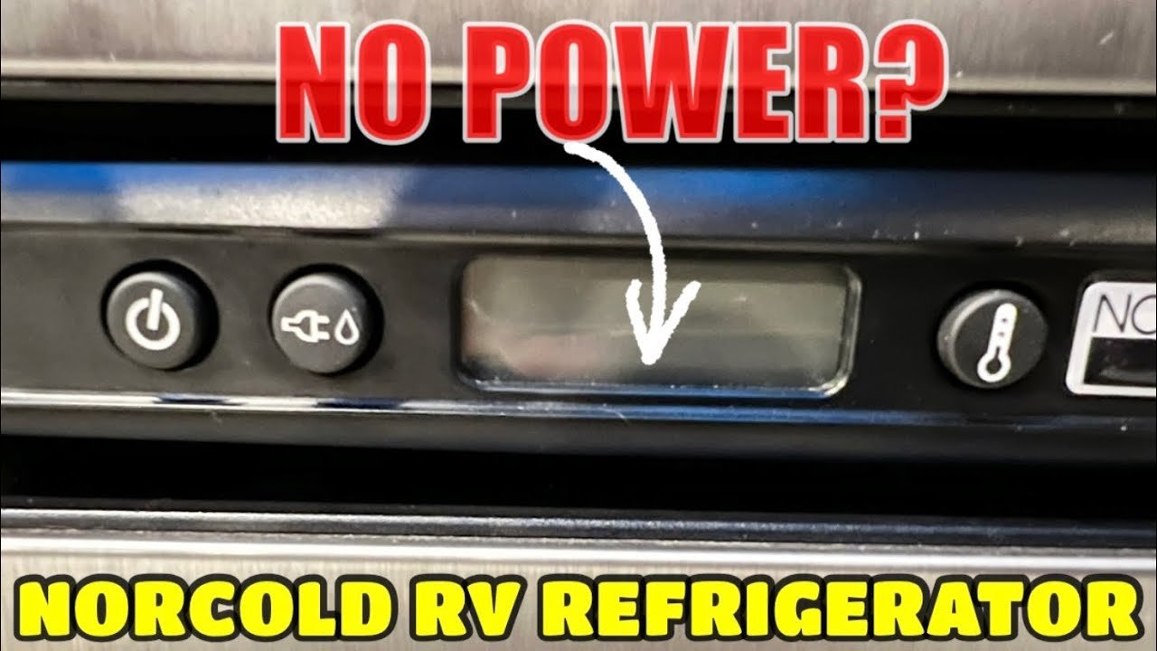 A hand flipping a circuit breaker switch inside an RV electrical power panel.