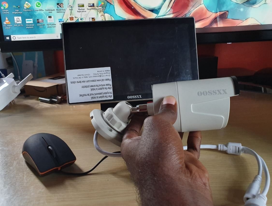 A wireless security camera mounted on a modern house exterior for home monitoring.