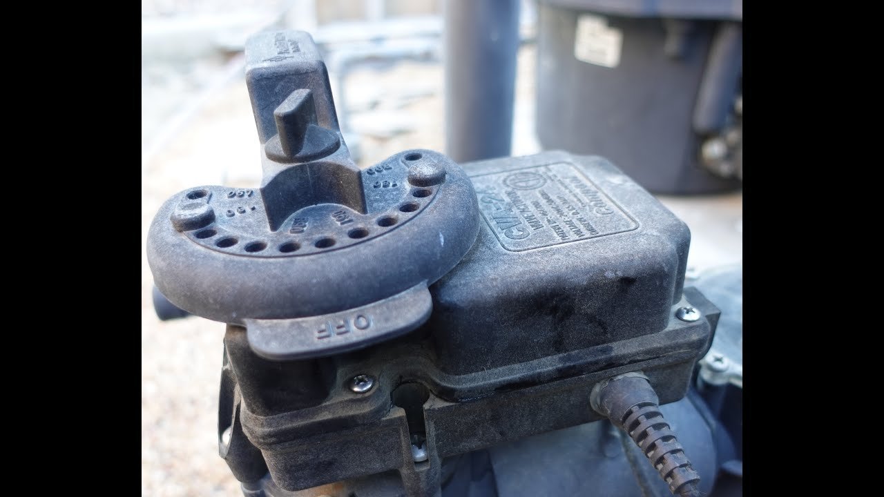 A row of professionally installed pool valve actuators on a plumbing manifold.