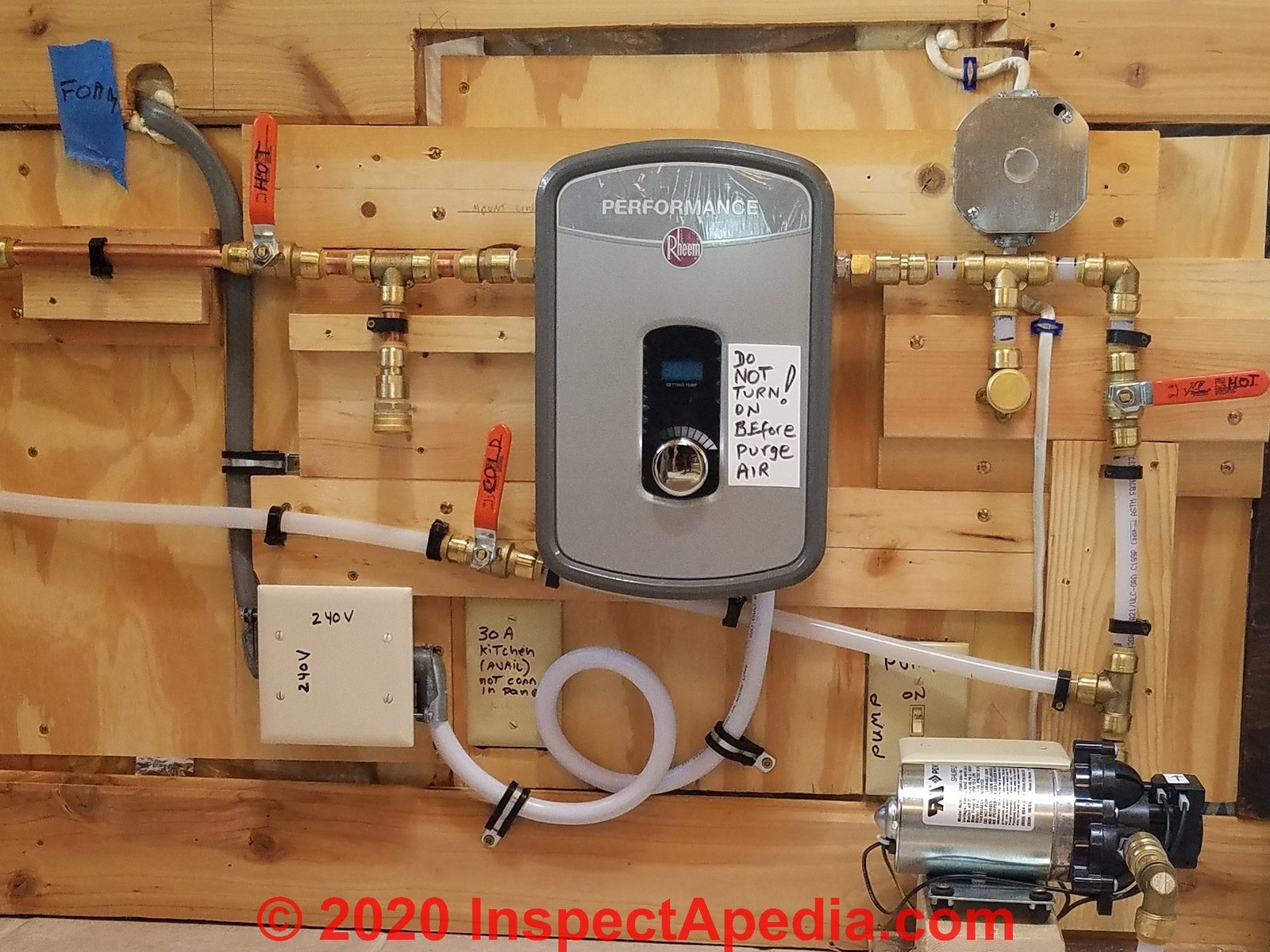 Close-up of a gas water heater thermocouple and pilot light assembly for troubleshooting.