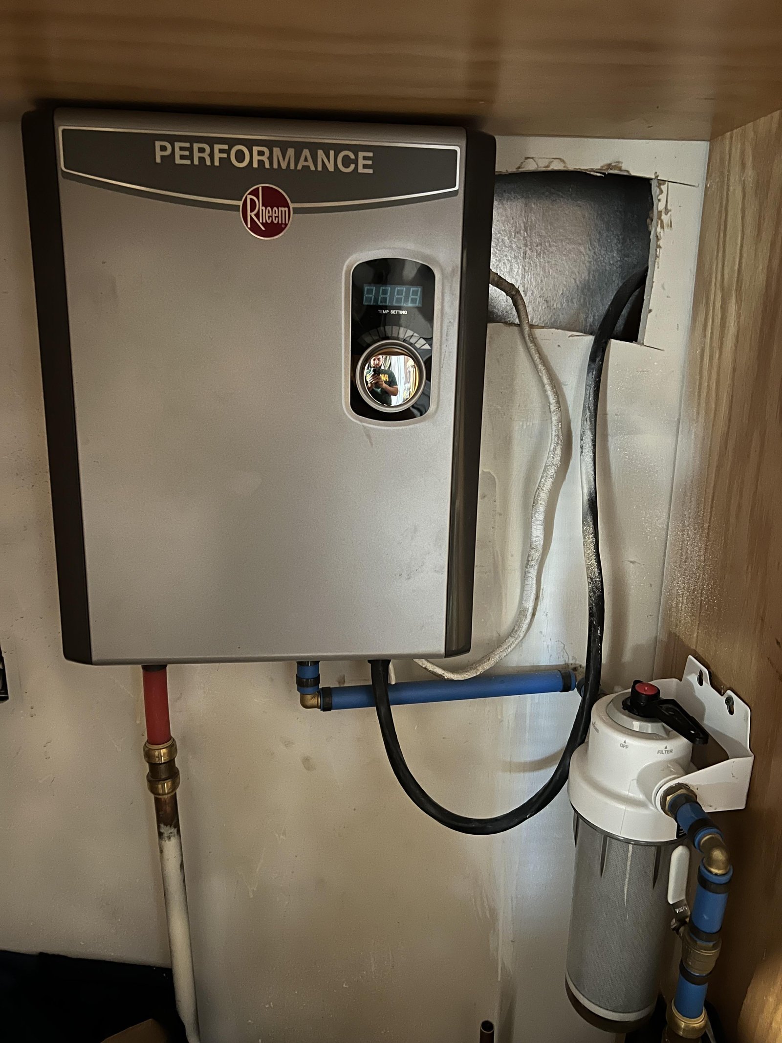 A tablet displaying troubleshooting tips for home hot water heater maintenance on a desk.
