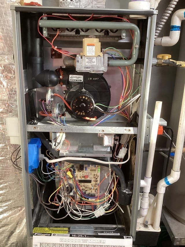 Professional tools laid out on a table for answering furnace troubleshooting questions.