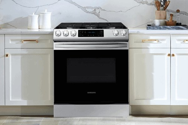 A modern stainless steel Samsung electric range sits in a clean, bright home kitchen.