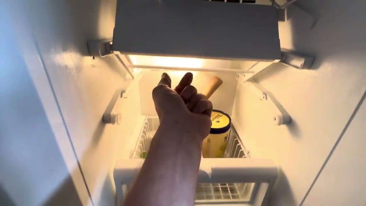 A stray ice cube wedged against the ice maker sensor inside the freezer.