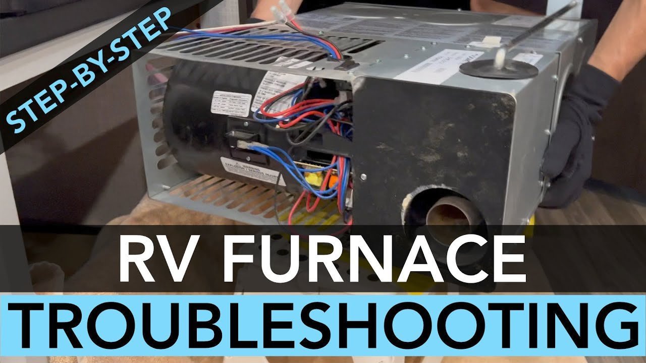 The internal electrical components and blower motor of a travel trailer furnace.