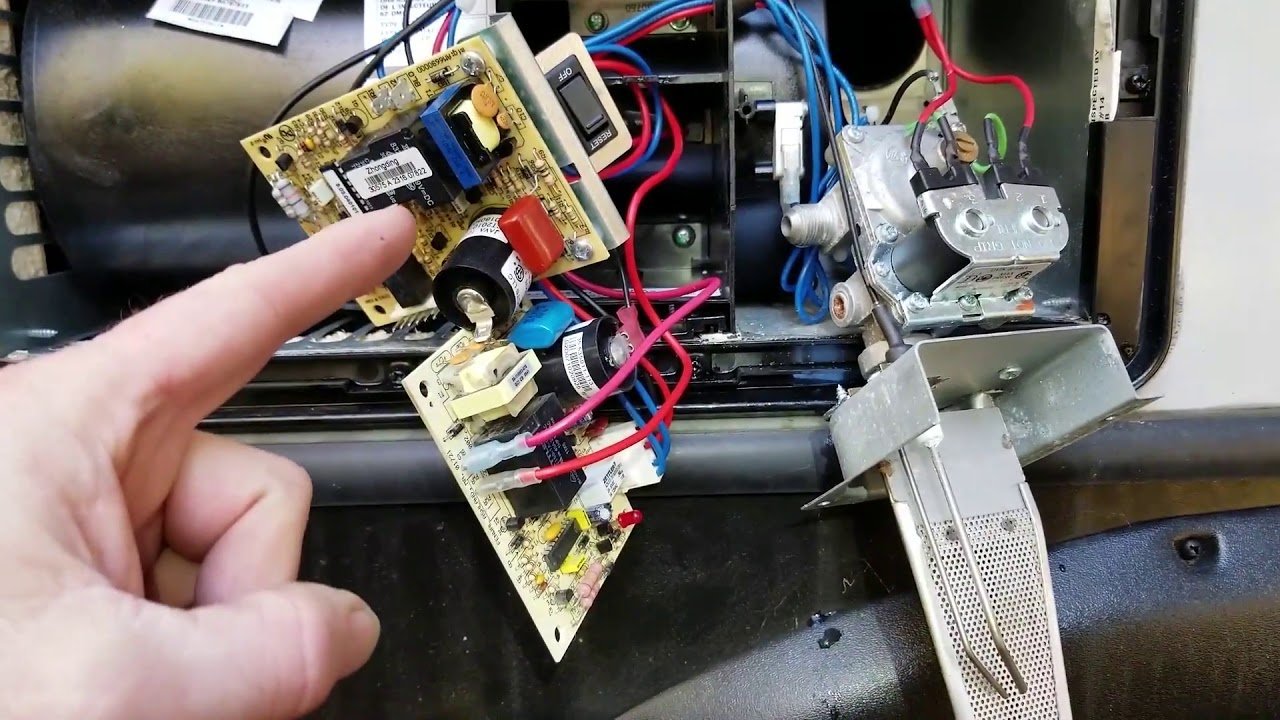 Removing batteries from a digital thermostat to reset a travel trailer furnace system.