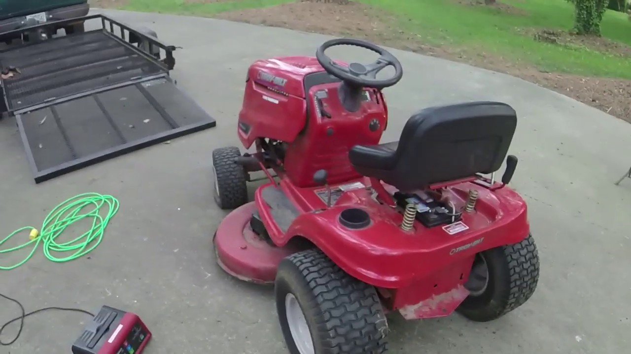 A Troy Bilt riding mower parked on a sunny lawn for maintenance troubleshooting.