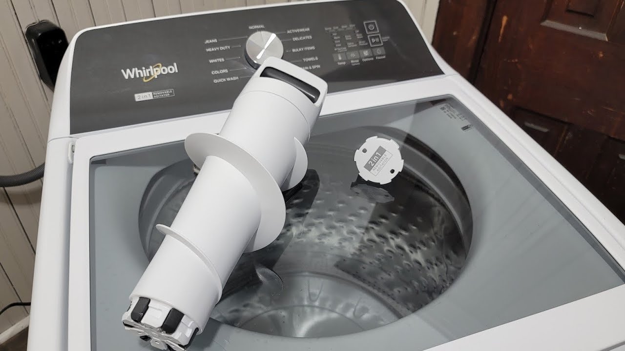 A clean laundry room setting with folded towels and an instruction manual.